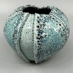 a blue vase sitting on top of a table