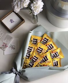 a bouquet of flowers and some candy on a table