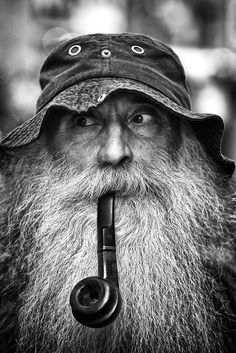 an old man with a pipe in his mouth