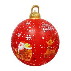 a red christmas ornament with santa and reindeers on it's side