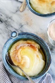 two bowls filled with food on top of a table