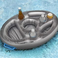 an inflatable pool with drinks and bottles on the bottom is floating down water