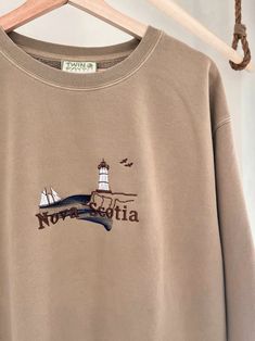 We sell primarily on our website. TwinRavenCo where we offer free shipping options and more colours.  Experience the charm of Nova Scotia, Canada in this vintage style crewneck. Featuring a mesmerizing ocean view and a tribute to the iconic Bluenose ship. 🍁 These crews are incredibly comfy, and unisex for that perfect oversized fit. Embroidered with the highest quality threads. Check out our socials for discounts, new releases, and to see how we run our shop: TwinRavenCo Embroidery stabilizer i Vintage Long Sleeve Sweatshirt With Letter Embroidery, Vintage Crew Neck Sweatshirt With Embroidered Logo, Vintage Long Sleeve Tops With Embroidered Text, Vintage Embroidered Crew Sweatshirt, Vintage Embroidered Logo Crew Neck Top, Vintage Crew Sweatshirt With Embroidery, Vintage Crew Neck Top With Embroidered Logo, Vintage Cotton Tops With Letter Embroidery, Vintage Embroidered Crew Neck Sweatshirt