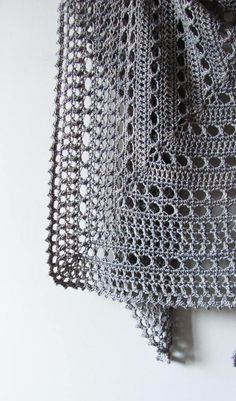 an intricate crochet piece is hanging on the wall