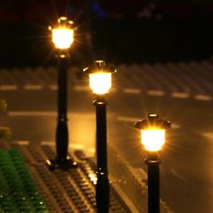 some lights that are sitting on top of a lego set in the dark, and one is lit up