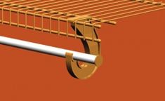 a close up of a metal shelf on an orange wall with a white rod attached to it