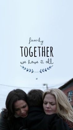 two women hugging each other in front of a sign that says, family together we love it all