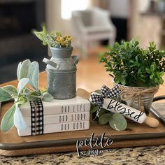 a tray with books and plants on it