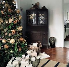 a christmas tree with presents in front of it