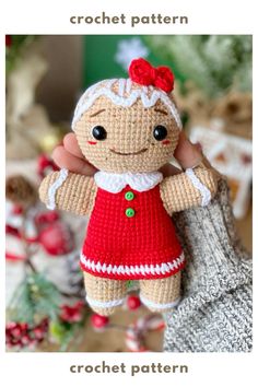 a small crochet doll is holding it's hand