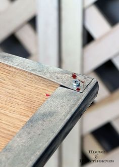 a close up view of a skateboard on a wooden board with holes in it