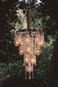 a chandelier hanging from a tree filled with lights