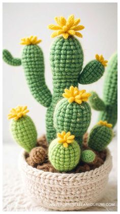 a crocheted cactus is sitting in a pot with yellow flowers on it's head