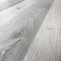 wood flooring that looks like it has been painted white and is very close to the ground