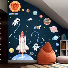 a room with space themed wallpaper and a rocket ship in the center, surrounded by planets