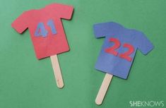 two popsicles made to look like shirts with numbers on them