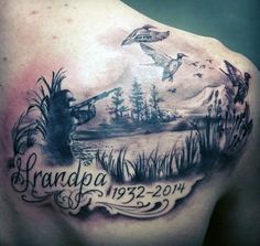 the back of a man's shoulder with an image of trees and birds on it