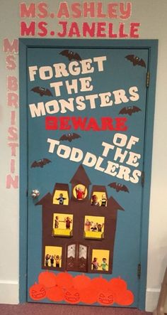 a door decorated to look like a house with bats on it and the words forget the monsters beware of the toddlers