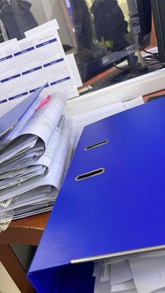 a pile of papers sitting on top of a desk