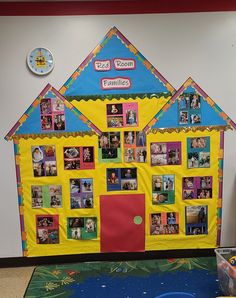 a colorful house with pictures on the front and side wall in an elementary school classroom