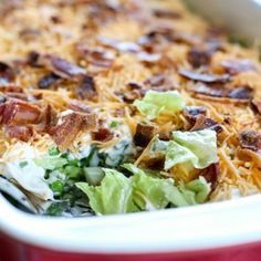 a casserole dish with bacon, lettuce and cheese