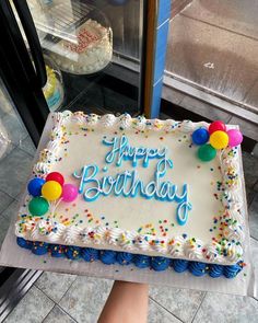 a birthday cake is being held by someone