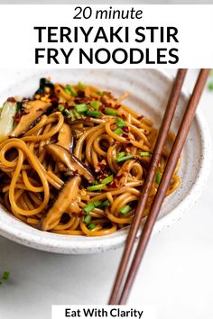 a bowl filled with noodles and chopsticks on top of a white countertop