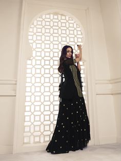 Look like a star in Malaika Arora's Black Floral Zari Sequines Embroidered Kurta Set. Crafted from luxurious georgette, crepe and net fabric and featuring a U-neck, short sleeves, and a curved top above the knee, this set brings grandeur and majestic embroidery artwork inspired by the Bollywood Diva herself. With the Dupatta measuring 30" in width and 90" in length, this set is sure to turn heads. TOP: Georgette, TOP INNER: Crepe, BOTTOM: Georgette with Crepe Inner, DUPATTA: Net, Dry Clean Black Georgette Kurti, Western Kurtis, Embroidery Artwork, Malaika Arora, A Line Kurta, Elegant Sets, Net Fabric, Anarkali Suit, Net Dupatta