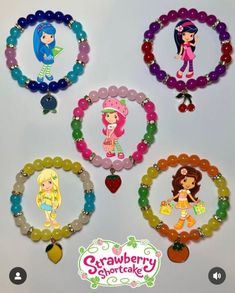 four bracelets with cartoon characters on them and the words crawberry shortcake