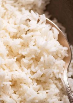 white rice in a bowl with a spoon