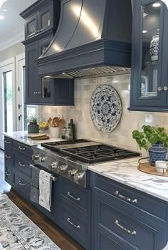 a kitchen with blue cabinets and marble counter tops