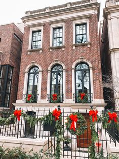 christmas decorations adorn the front of this brick building