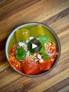 a bowl filled with food on top of a wooden table