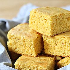 a pile of cornbreads sitting on top of a white cloth in a bowl