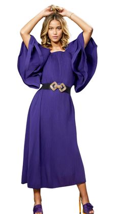 This stunning Purple Flutter Sleeve Dress features layered flutter sleeves, adding a touch of elegance and femininity to your look. The rich purple hue makes a statement while the flutter sleeves provide a subtle and stylish touch. Perfect for any special occasion, this dress is sure to turn heads. Chic Purple Formal Dress, Elegant Purple Midi Dress For Party, Purple Midi Dress For Wedding Guest, Elegant Purple Midi Dress For Evening, Elegant Flutter Sleeve Midi Dress For Party, Elegant Party Midi Dress With Flutter Sleeves, Formal Dresses With Ruffles And Butterfly Sleeves, Elegant Purple Midi Dress For Wedding Guest, Chic Party Midi Dress With Cape Sleeves