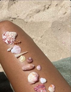 shells and starfish on the back of a woman's arm