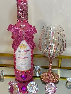 a bottle of wine sitting next to a crystal goblet