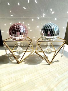 two shiny disco balls sitting next to each other