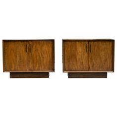 two wooden cabinets sitting next to each other