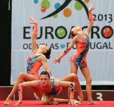 three women doing acrobatic tricks on the floor