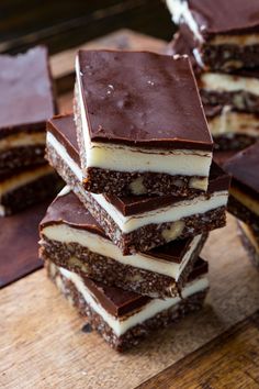 several pieces of cake sitting on top of a wooden cutting board next to each other