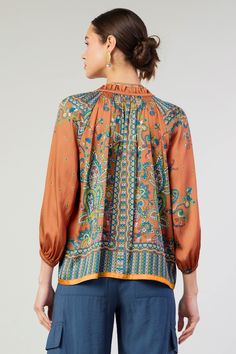 An ornate paisley print with an intricate border decorates this airy long-sleeve blouse. Accented by smocking and ruffles, the split-neck top features a slender self-tie and falls to a loose, easy shape with turquoise tracing the hem. "•Split neckline with self-tie •Ruffle trim •Smocking •Long sleeves •Elasticized cuffs •Relaxed fit Item number 2430488 100% Polyester Gentle cycle cold Line Dry Patterned Long Sleeve Top With Ruffles, Patterned Long Sleeve Boho Print Blouse, Fall Bohemian Split Neck Tops, Casual Long Sleeve Peasant Top With Paisley Print, Fall Boho Print Long Sleeve Blouse, Long Sleeve Boho Print Blouse For Fall, Patterned Boho Print Long Sleeve Top, Patterned Long Sleeve Blouse With Ruffles, Flowy Bohemian Tops With Smocked Cuffs