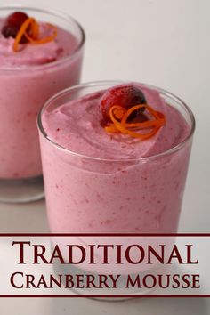 two glasses filled with food on top of a white table next to the words traditional cranberry mousse