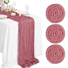 the table is set with pink napkins and place settings