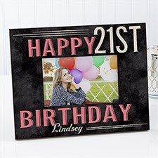 a happy 21st birthday photo frame on a table with balloons and candles in the background