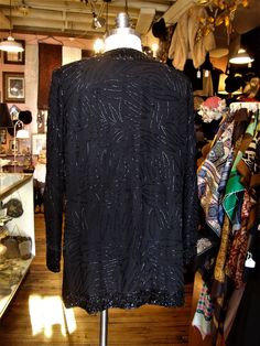 "This is a vintage beaded evening jacket by Brilliante from the 1980's or 90's. It closes down the front with sets of hooks and eyes, is lined and has removable shoulder pads. Great for the holidays! It's in great condition! Comes from a smoke free home. Measurements: Bust: 38\" Waist: 38\" Hip: 40\" Across Shoulder: 15\" Sleeve Length: 23\" Length from Shoulder: 31.5\" Please ask me any questions you may have before buying as this is a final sale. Please know your measurements and allow for mov Sequined Outerwear For Holiday Evenings, Vintage Formal Outerwear With Sequins, Vintage Sequined Formal Outerwear, Embellished Holiday Outerwear For Evening Events, Holiday Evening Embellished Outerwear, Black Holiday Evening Outerwear, Fitted Beaded Evening Outerwear, Vintage Sequin Outerwear For Night Out, Vintage Beaded Evening Outerwear