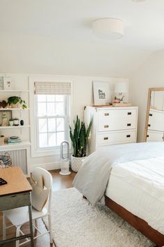 a bedroom with a bed, desk and chair in it's centerpieces