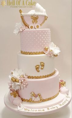 a three tiered cake with pink and gold decorations