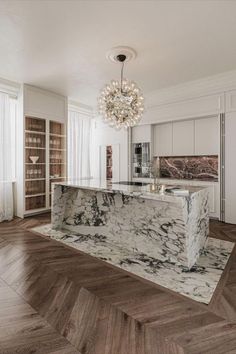 an elegant kitchen with marble counter tops and wood flooring is pictured in this image