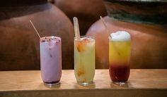 three different types of drinks sitting on a table